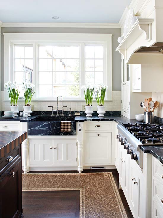 Kitchen with white cabinets store and dark countertops