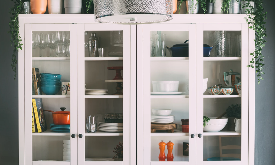 Dishes and kitchen ware arranged in a cupboard